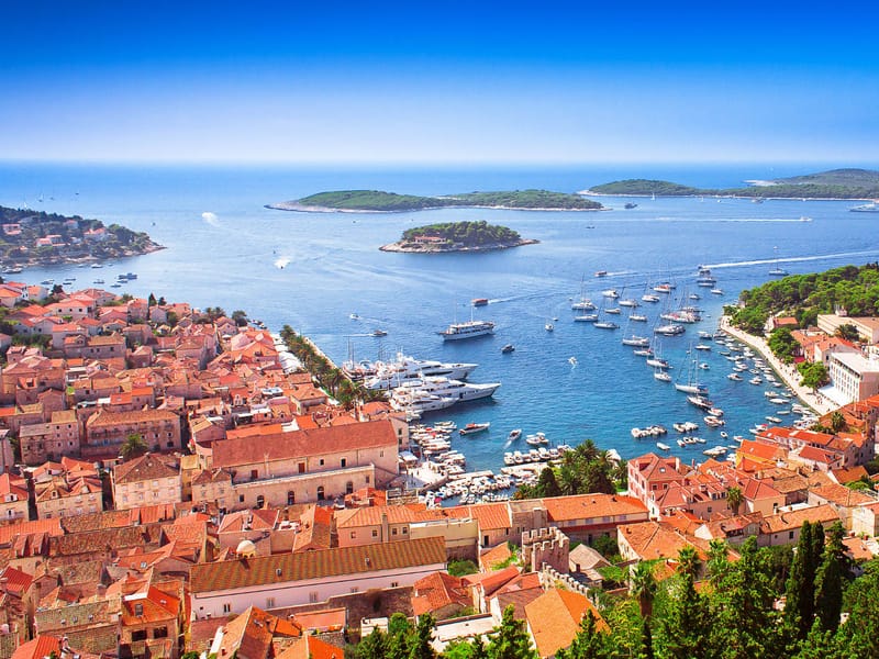 Hvar town by boat from Dubrovnik — harbour, Fortica fortress and the Pakleni islands offshore