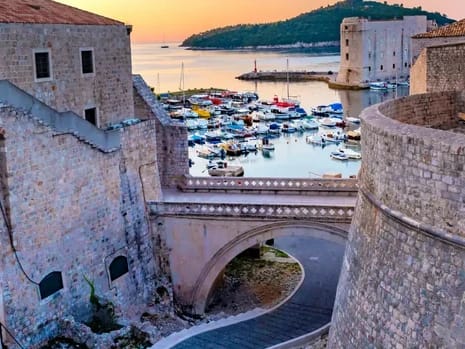 Private sunset boat tour Dubrovnik — Old Town walls and Fort Lovrijenac from the sea in evening light